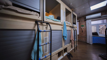 Capsule hotel room showing individual sleeping boxes offering privacy and convenienceの写真素材