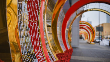 Christmas decorations creating a tunnel of lights on a city streetの写真素材