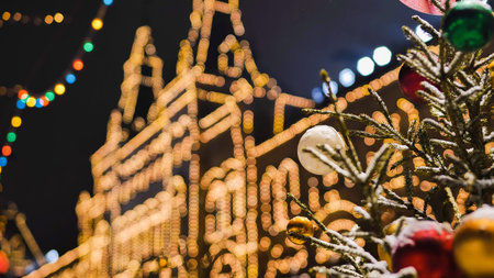 Christmas tree with colorful balls decorating Moscow GUM building at night