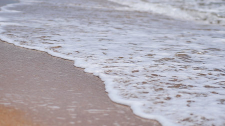 Soft wave gently washing sandy beach in Crimea, creating relaxing seascapeの写真素材
