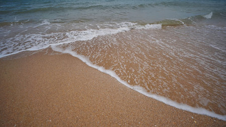 Soft wave washing golden sand beach