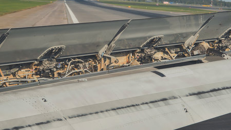 Airplane spoilers opening during landing on runwayの写真素材