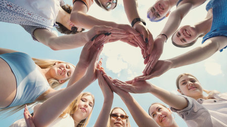 School friends united in a circle, showing teamwork and collaboration against a blue sky backdrop