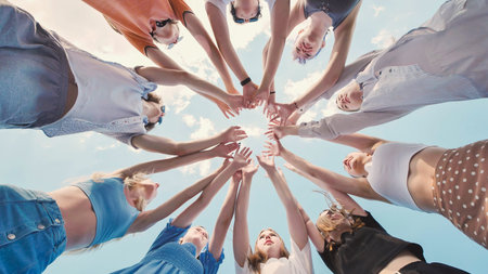 School friends coming together in a circle, representing their unity, teamwork, and strong bond