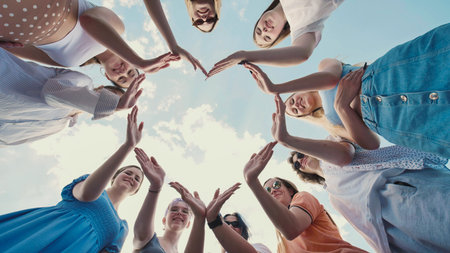 School friends joining hands to create a star shape, representing teamwork and solidarity
