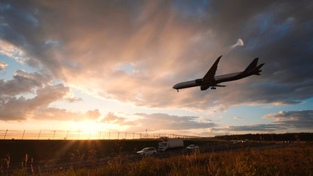 Passenger airplane landing at sunsetの写真素材