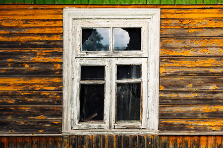 Old broken window with peeling paint in abandoned houseの写真素材