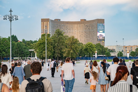 Moscow, Russia - August 25, 2025: Crowd walking towards Cosmos Hotel in Moscow, enjoying summer evening at VDNKh parkのeditorial素材