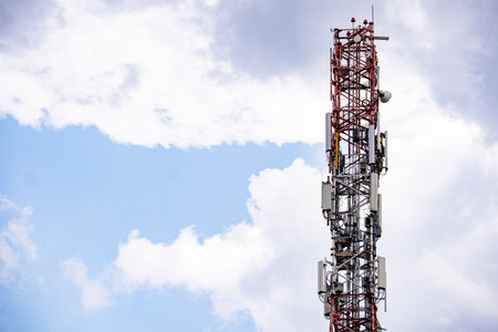 Telecommunication tower providing cellular and mobile signal coverage against a cloudy sky