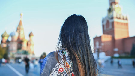 Bangladeshi woman looking at Saint Basils Cathedral in Red Square, Moscow tourism