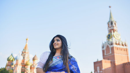 Bangladeshi woman in Moscow enjoying Red Square views, wearing traditional saree