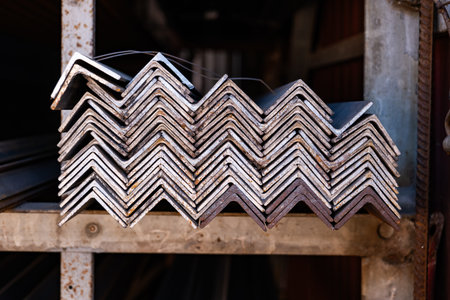 Stacked metal angle iron bars creating abstract pattern for construction industryの写真素材
