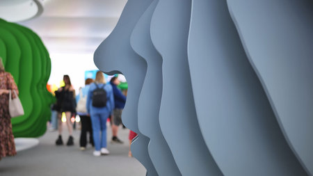 Abstract layered faces sculpture creating modern art installation in public exhibition