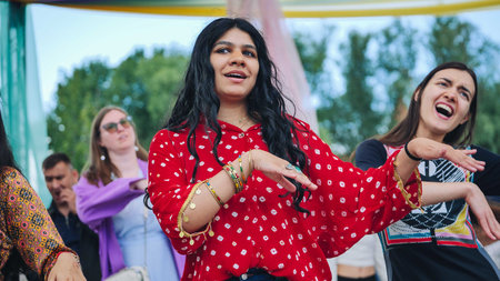 Moscow, Russia - August 25, 2025: Indian culture festival in Moscow with young women enjoying a...