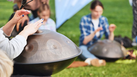 People playing hang drums and handpans at India Day festival in Moscow park