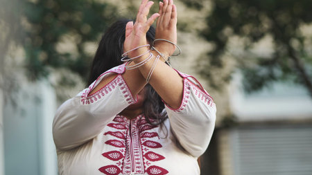 Indian woman celebrating Ganesh Chaturthi with traditional gestures and bangles