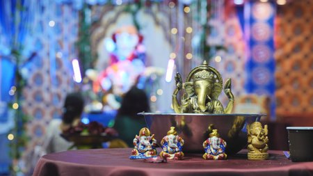 Ganesha statues displayed on a table during the Ganesh Chaturthi festival in a temple