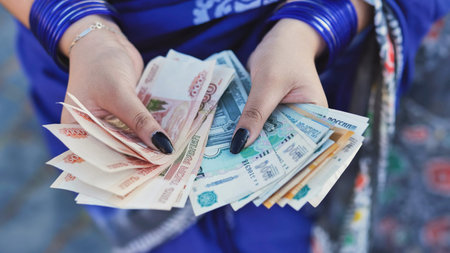 Womans hands holding Russian rubles, concept of finance, economy, and prosperity