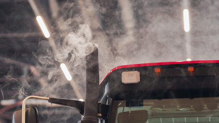 Tractor exhaust pipe emitting smoke indoors, showing air pollution and greenhouse gases