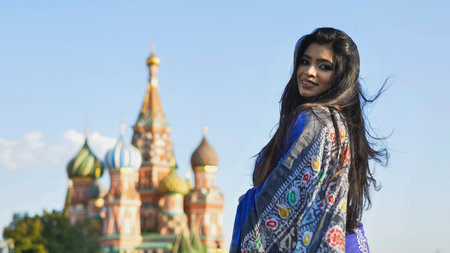 Bangladeshi woman smiling in traditional saree near Saint Basils Cathedral, Moscow