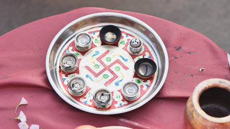 Ganesh Chaturthi puja thali with swastika symbol during Hindu religious ceremony