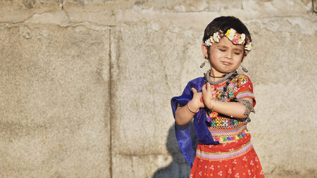 Delhi, India - September 19, 2025: Smiling Indian girl celebrating Ganesh Chaturthi festival,...