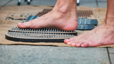 Man practicing yoga and meditation using sadhu boards in India