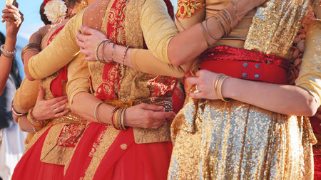Women dressed in traditional Indian attire embracing at a cultural festival in Moscow