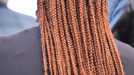 Woman showing brown box braids hairstyle texture