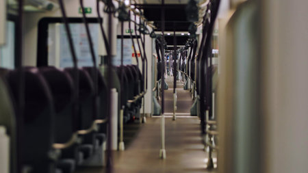 Empty modern train car showing seats and aisle