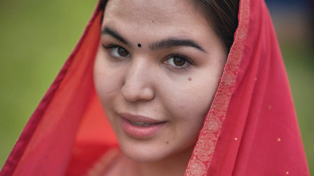 Moscow, Russia - August 25, 2025: Indian woman wearing bindi and traditional red sari during India...