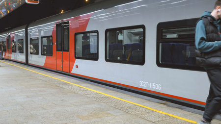Modern train arriving at Moscow station platform during peak hour commute