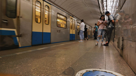 Moscow, Russia - June 17, 2024: Tourists waiting for subway train in Moscow Metro station