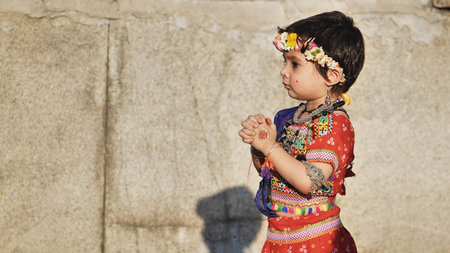 Delhi, India - September 19, 2025: Young Indian child celebrating Ganesh Chaturthi wearing traditional dress and flower crownのeditorial素材