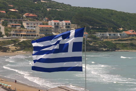 Greek flag at beach Agios Stefanos Corfu, Greece の写真素材