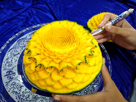 Thai fruit carving with handの写真素材