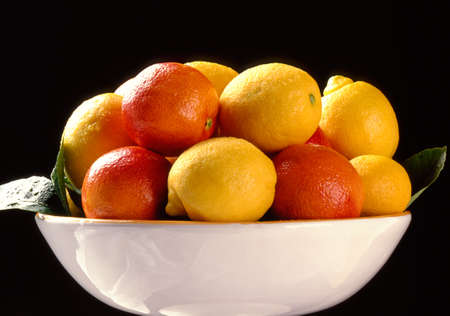 Citrus fruits in plate on black backgroundの写真素材