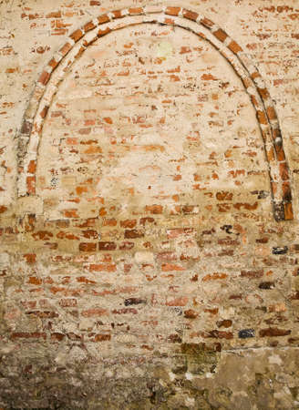 Wall of red brick with antique semicircular arch の写真素材