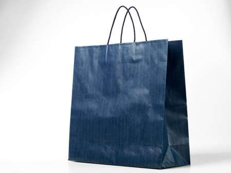 Blue shopping bag on white with shadowの写真素材