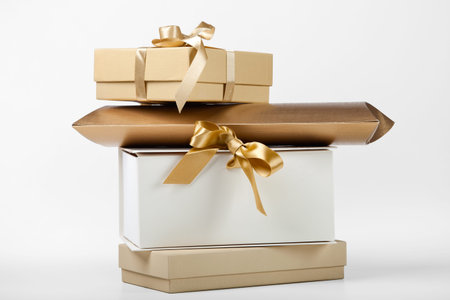 Four gift boxes with golden bow on white.の写真素材