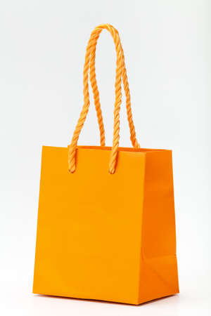 Orange shopping bag on white.の写真素材