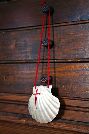 Shell with red cross, souvenir of the camino de Santiago de Compostela, Galicia, Spain.
