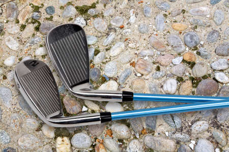 Two golf clubs on foothpath の写真素材