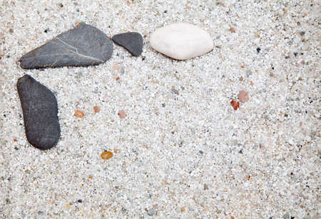 Several grey and white stone on sandの写真素材