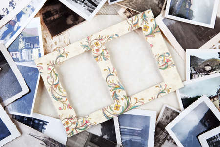 A pile of old photographs with space for your logo or text.の写真素材