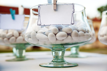 Candies in a goblet with blank label.