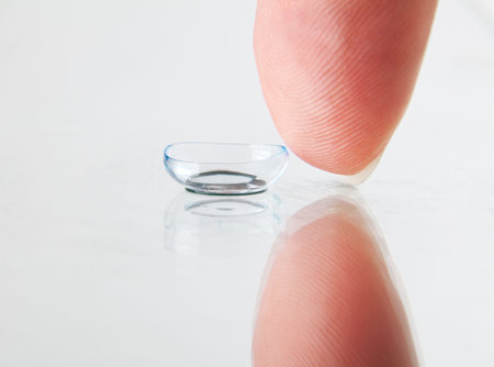 Detail of soft contact lens and fingerの写真素材