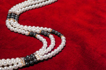 Pearl necklace on red velvetの写真素材
