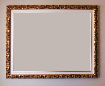 Golden empty frame on pink wall