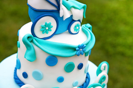 Detail of baby cake with blue and green ballons